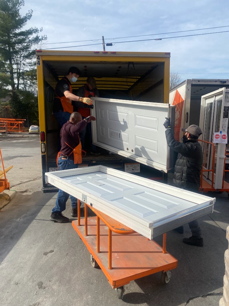 Team loading doors into truck