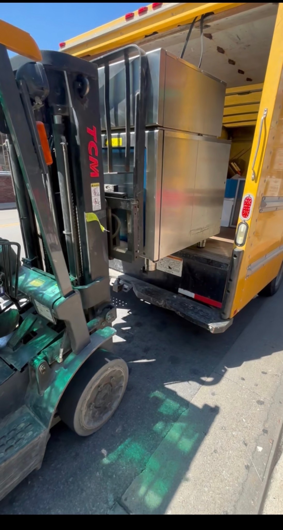 Forklift loading equipment into truck